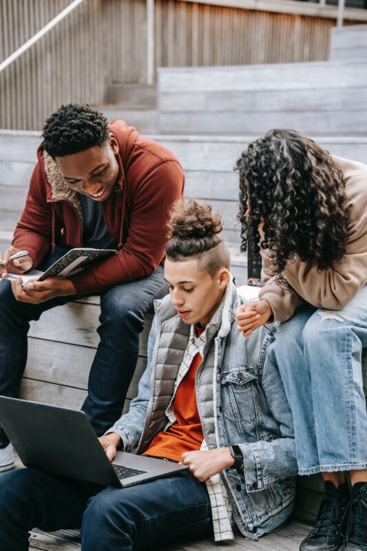 Teenagers looking at a laptop